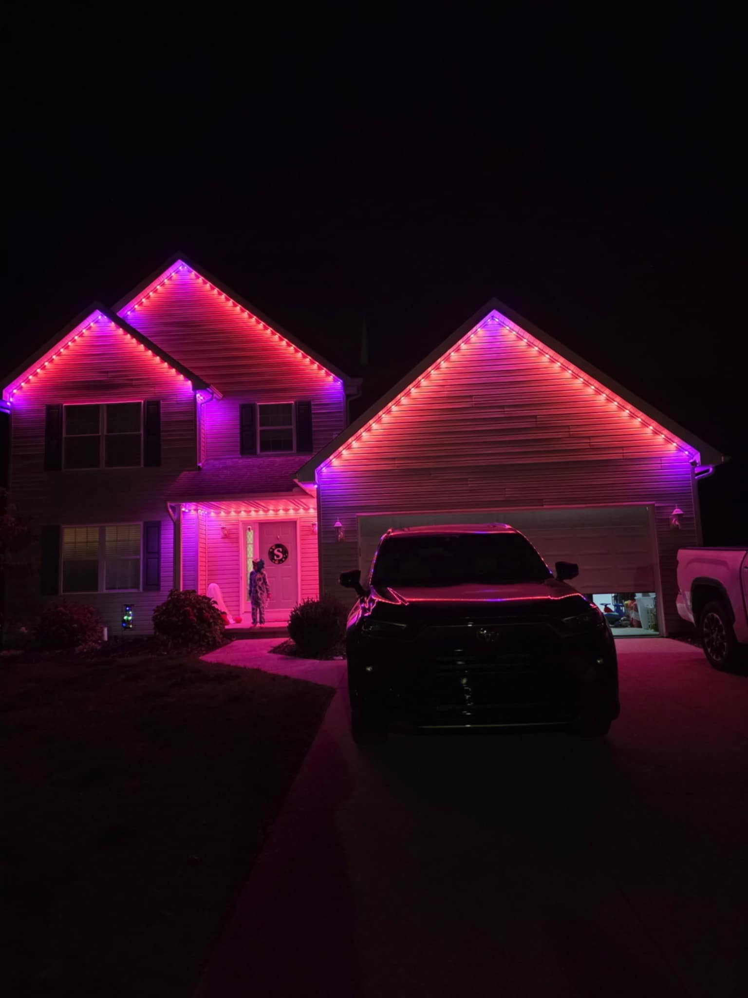 Home lit in vivid pink and magenta